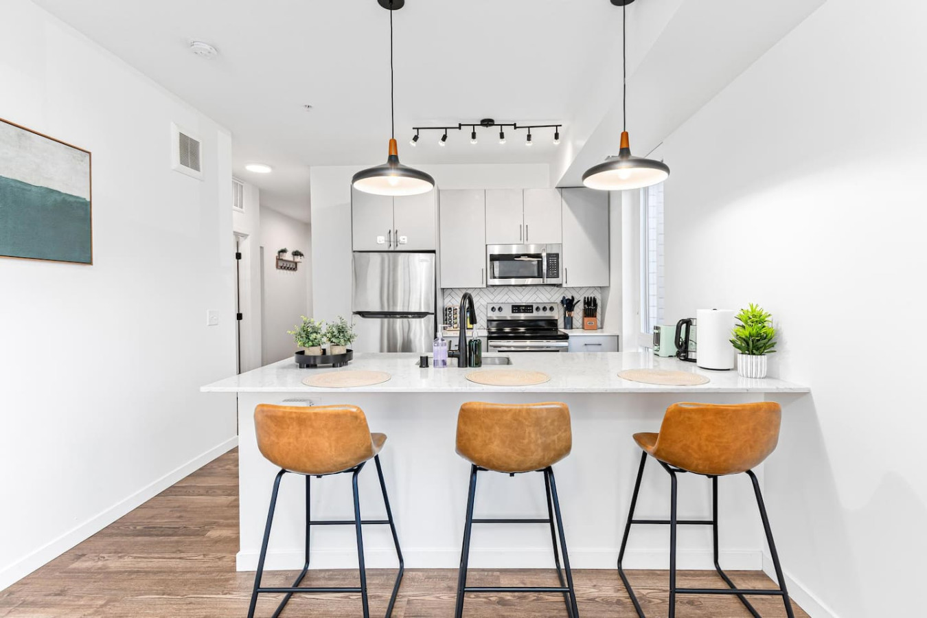 You imagine yourself mixing a cocktail at the stylish home bar, surrounded by a space that’s perfect for socializing.