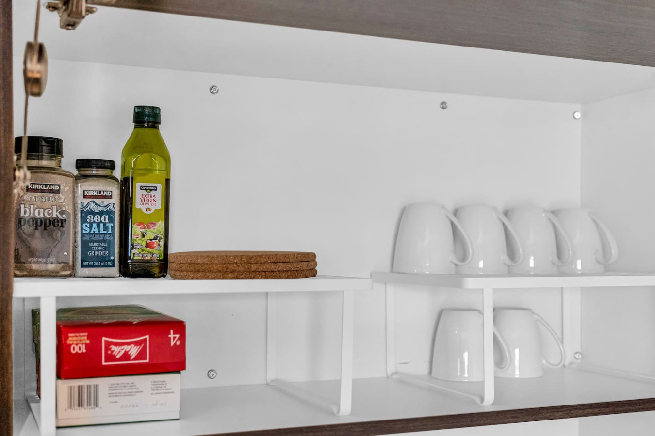 A well eqipped modern cabinetry, open shelving, and stylish lighting.