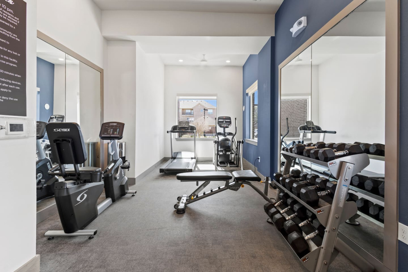 Dedicated space featuring a wide range of dumbbells, benches, and mirrors for strength and resistance training