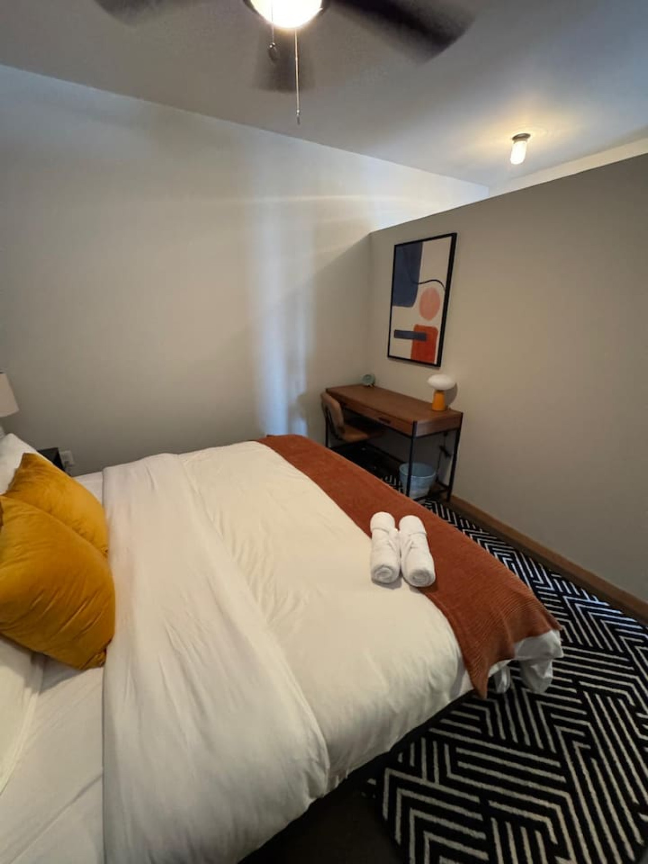 Luxurious queen bedroom featuring a comfortable bed, elegant decor, and plenty of natural light for a rejuvenating sleep.