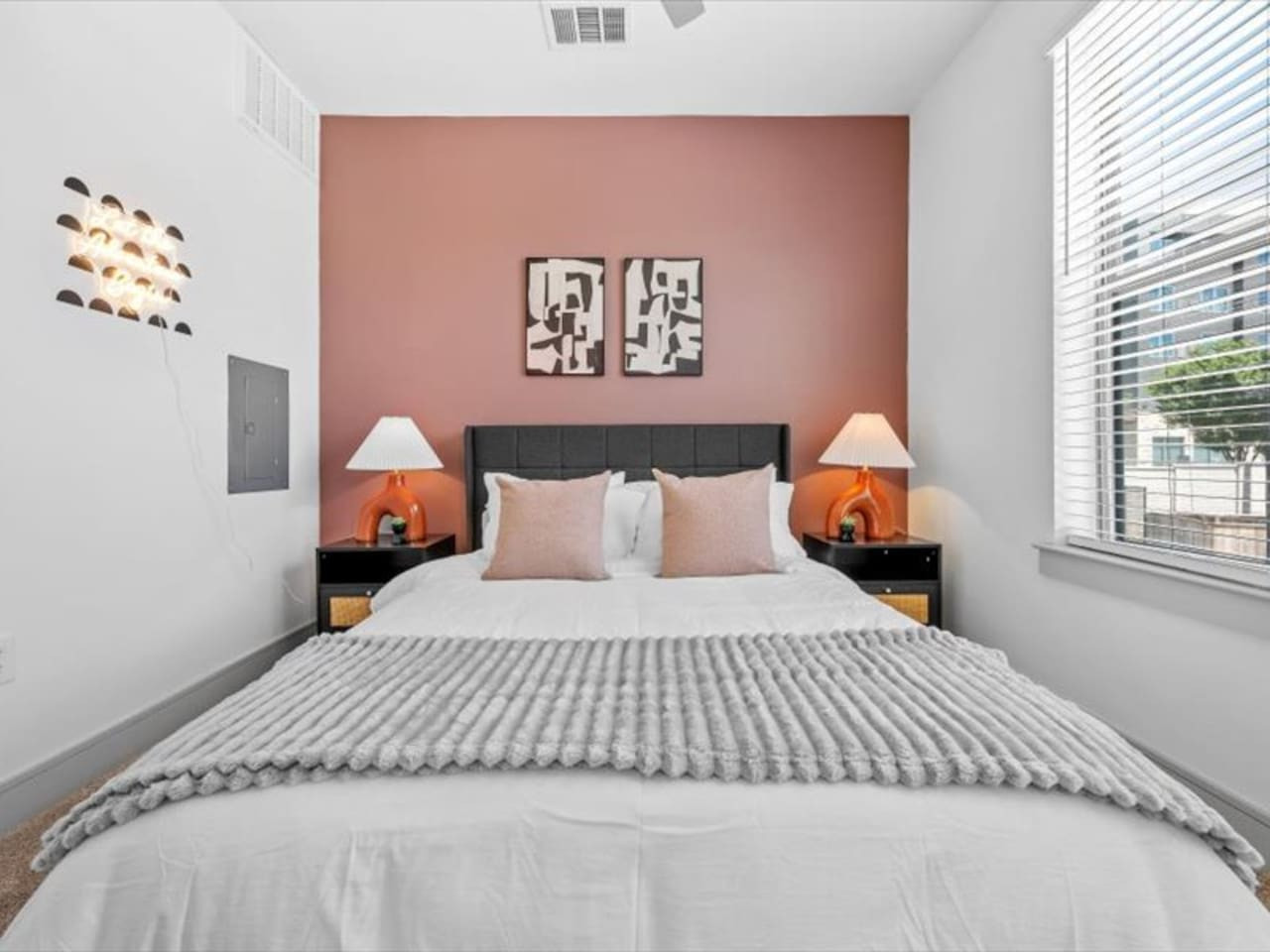 You feel enveloped in comfort as you relax on the queen bed, surrounded by a room designed for tranquility.