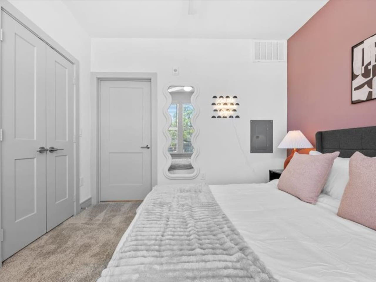 You feel enveloped in comfort as you relax on the queen bed, surrounded by a room designed for tranquility.