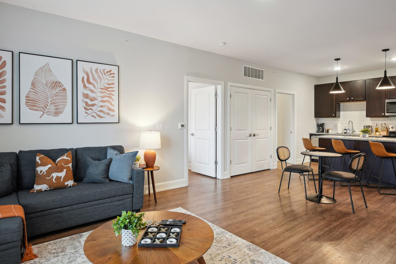 Spacious open-concept living and dining area featuring a vibrant sofa, modern furnishings, and a stylish entertainment setup—ideal for gatherings and relaxation.