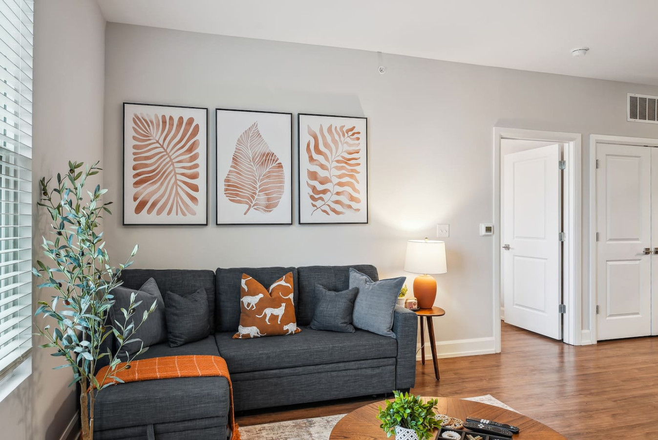 Bright and airy living room with plush seating, a large TV, and tasteful decor, creating the perfect space for relaxation and entertainment.