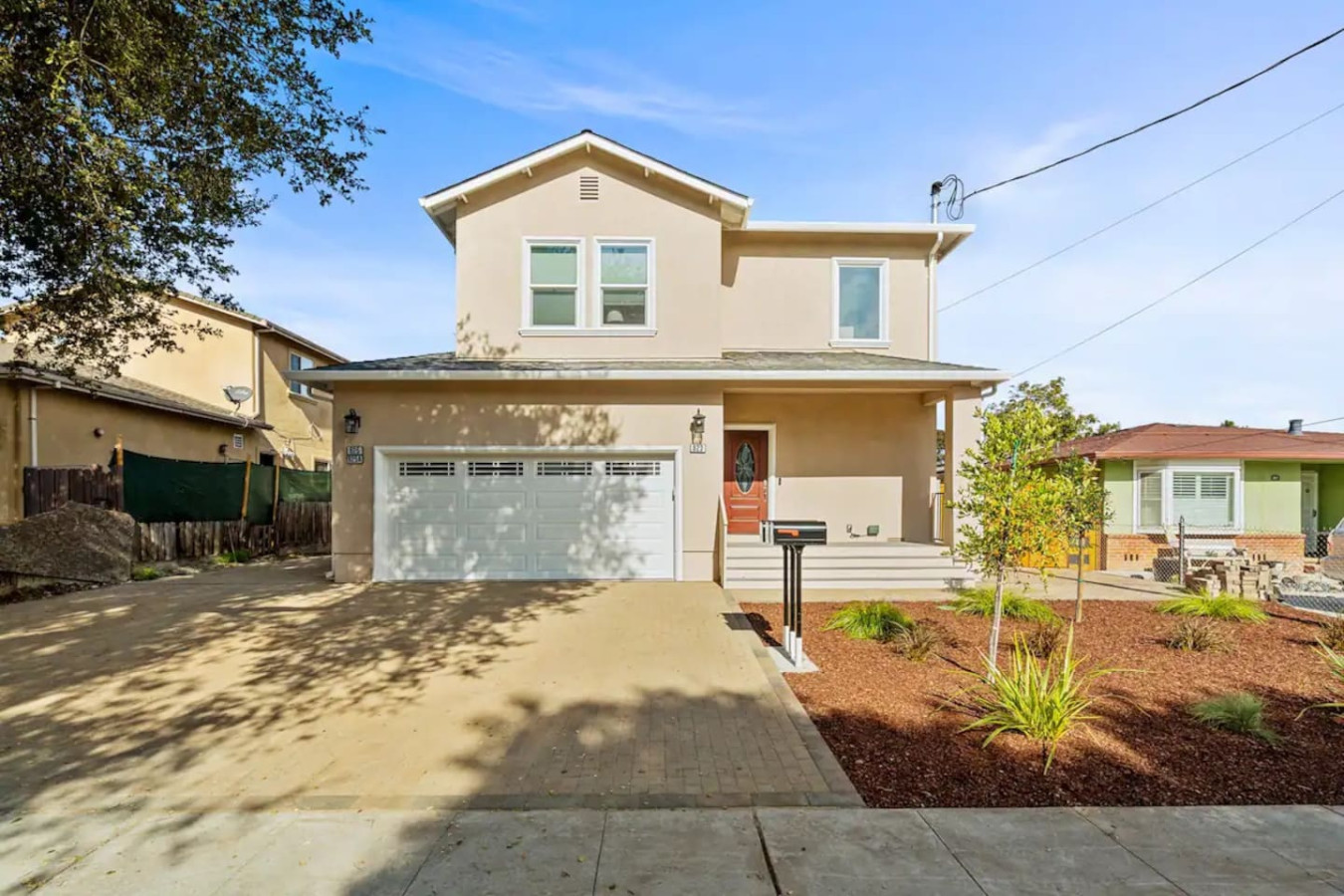 The house’s exterior is a blend of modern and classic design elements, creating a welcoming and stylish facade.