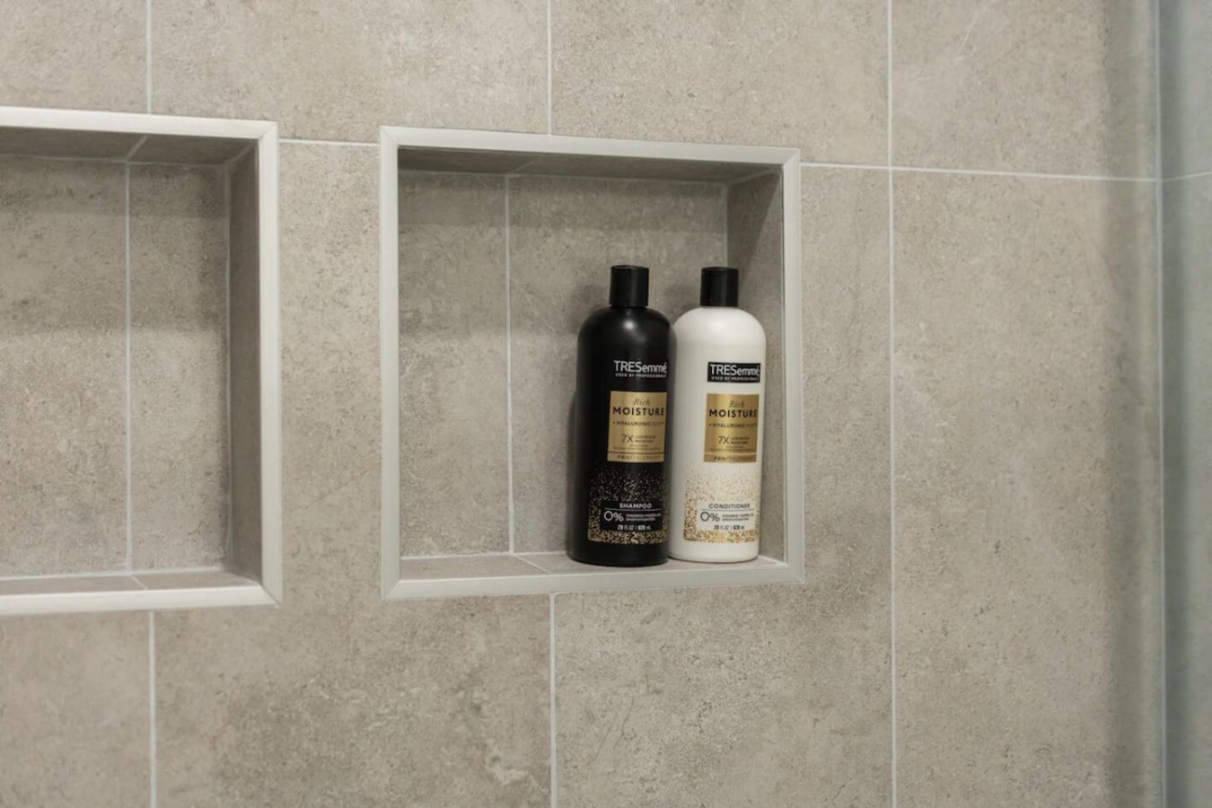 Immaculate bathroom featuring a spacious shower, fresh towels, and complimentary toiletries for a spa-like experience.