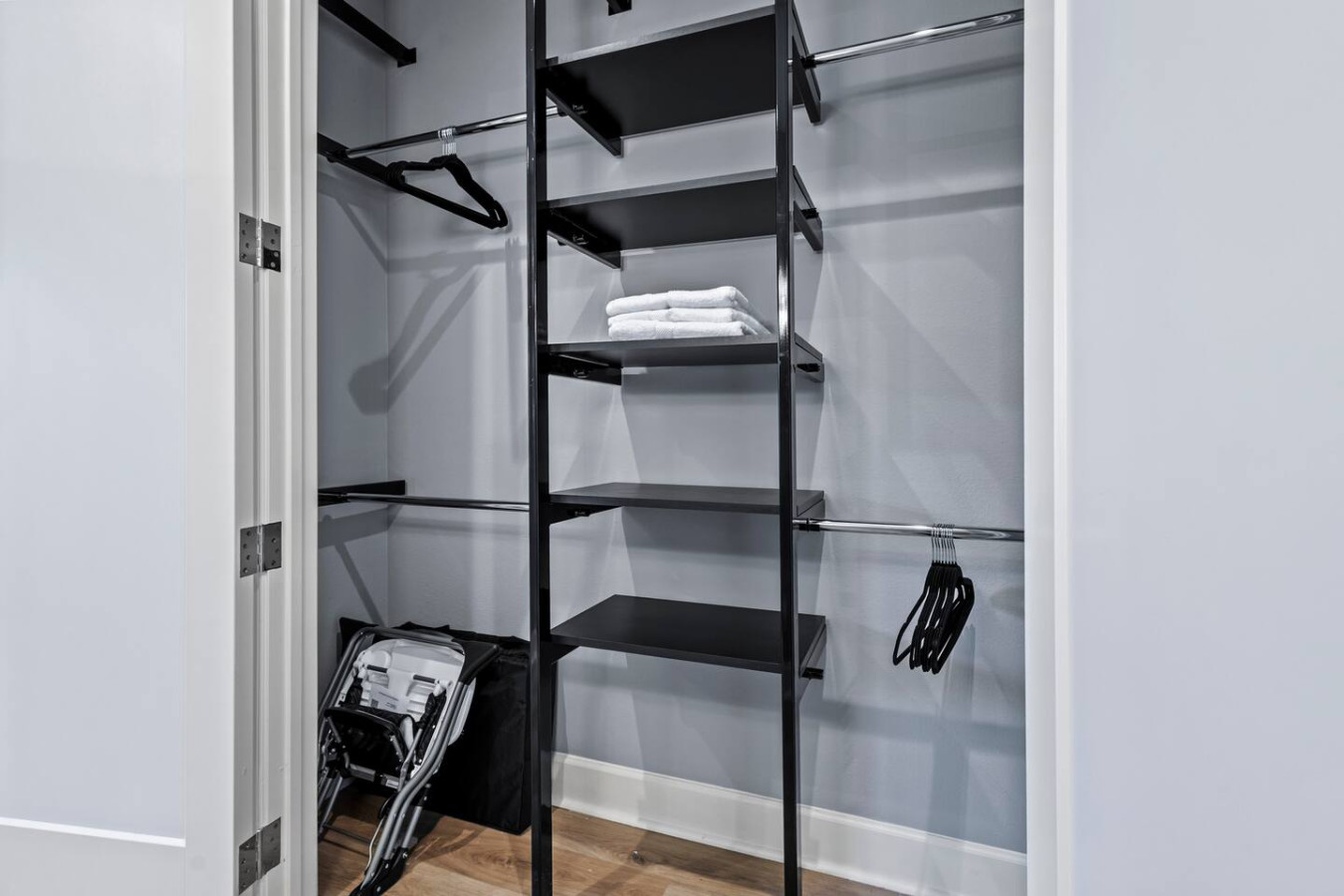 Closet with hangers, portable crib, and high chair