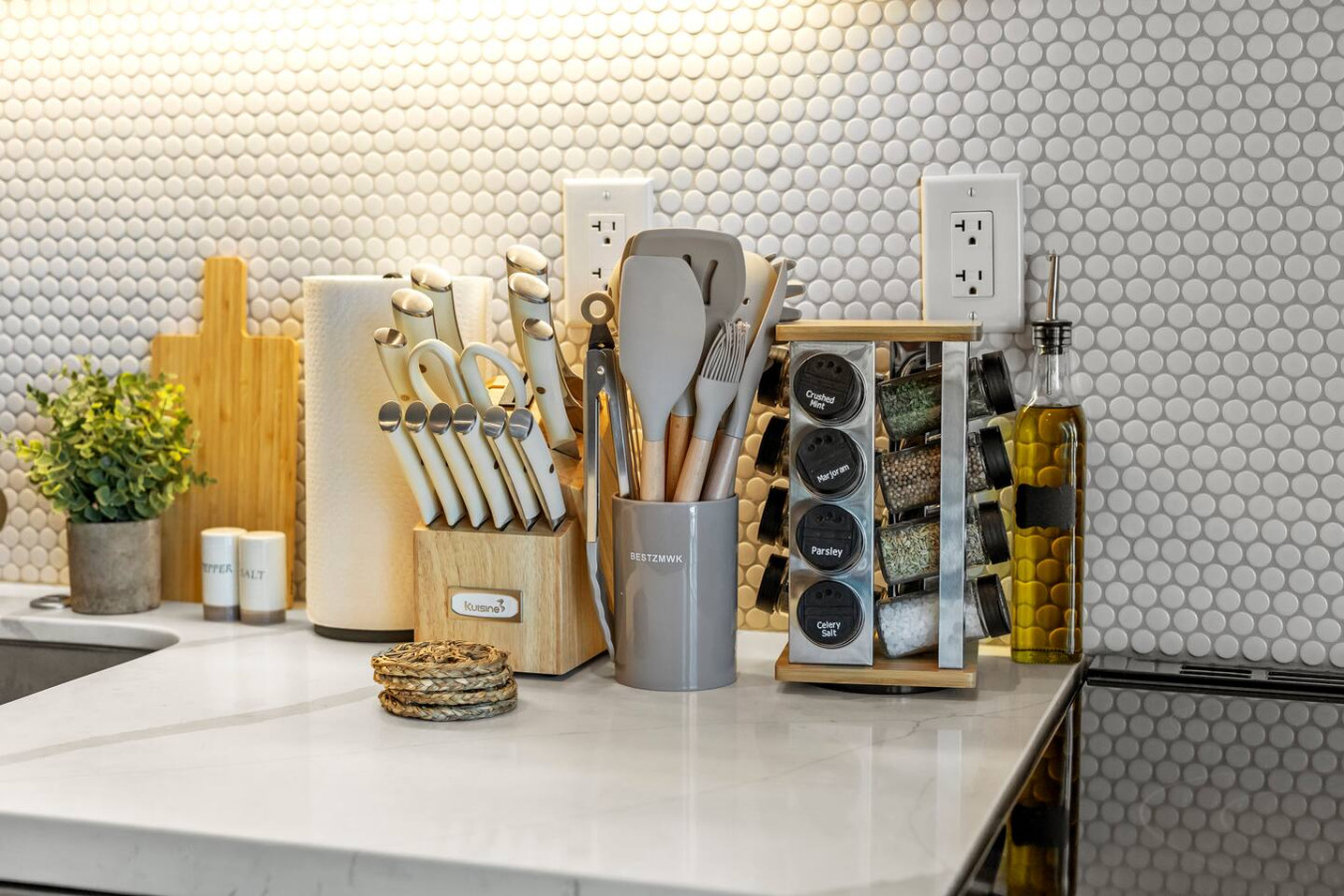 Fully stocked cooking tools, spices, and style in one photo.