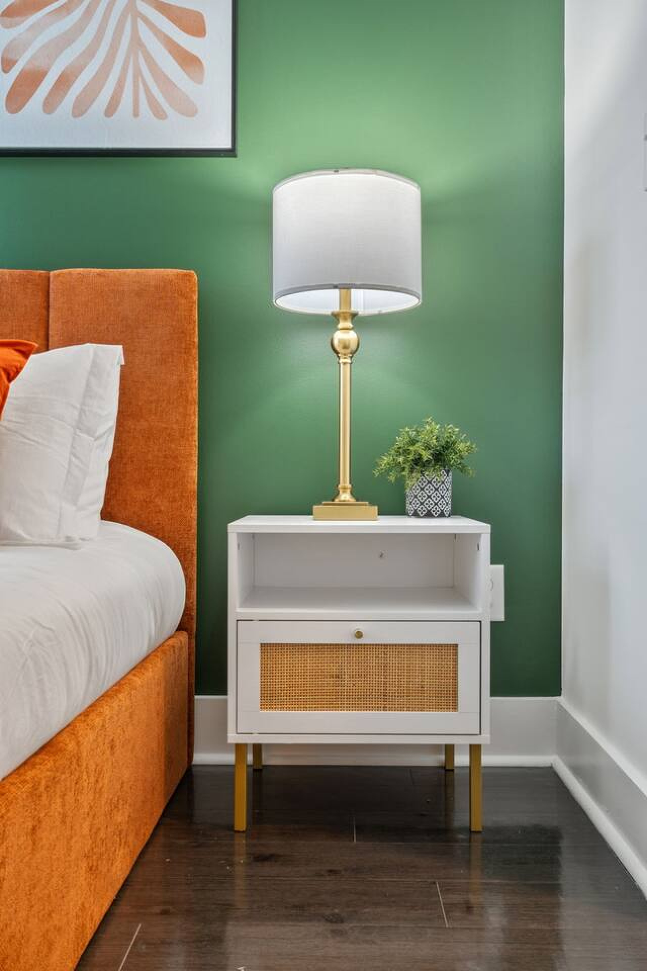 Everything within reach including bedside charging station, ambient lighting, and storage for personal items in this carefully curated space.