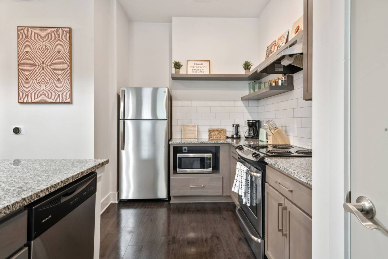 Complete kitchen with full-size refrigerator, microwave, dishwasher, and coffee station. Perfect for preparing meals and saving on dining costs.