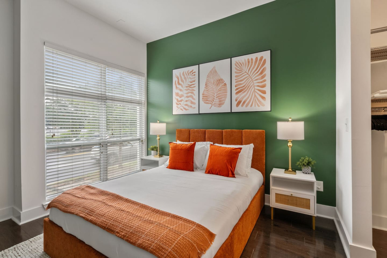 Queen bed with premium linens, statement green accent wall, and adjustable lighting that's perfect for unwinding after exploring the city.