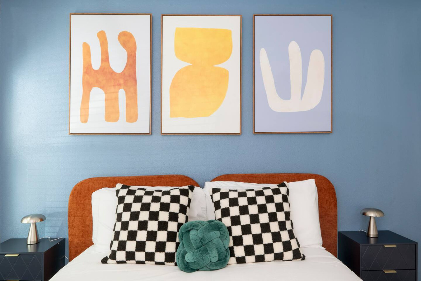 Modern artwork and soft bedding make this room feel like home