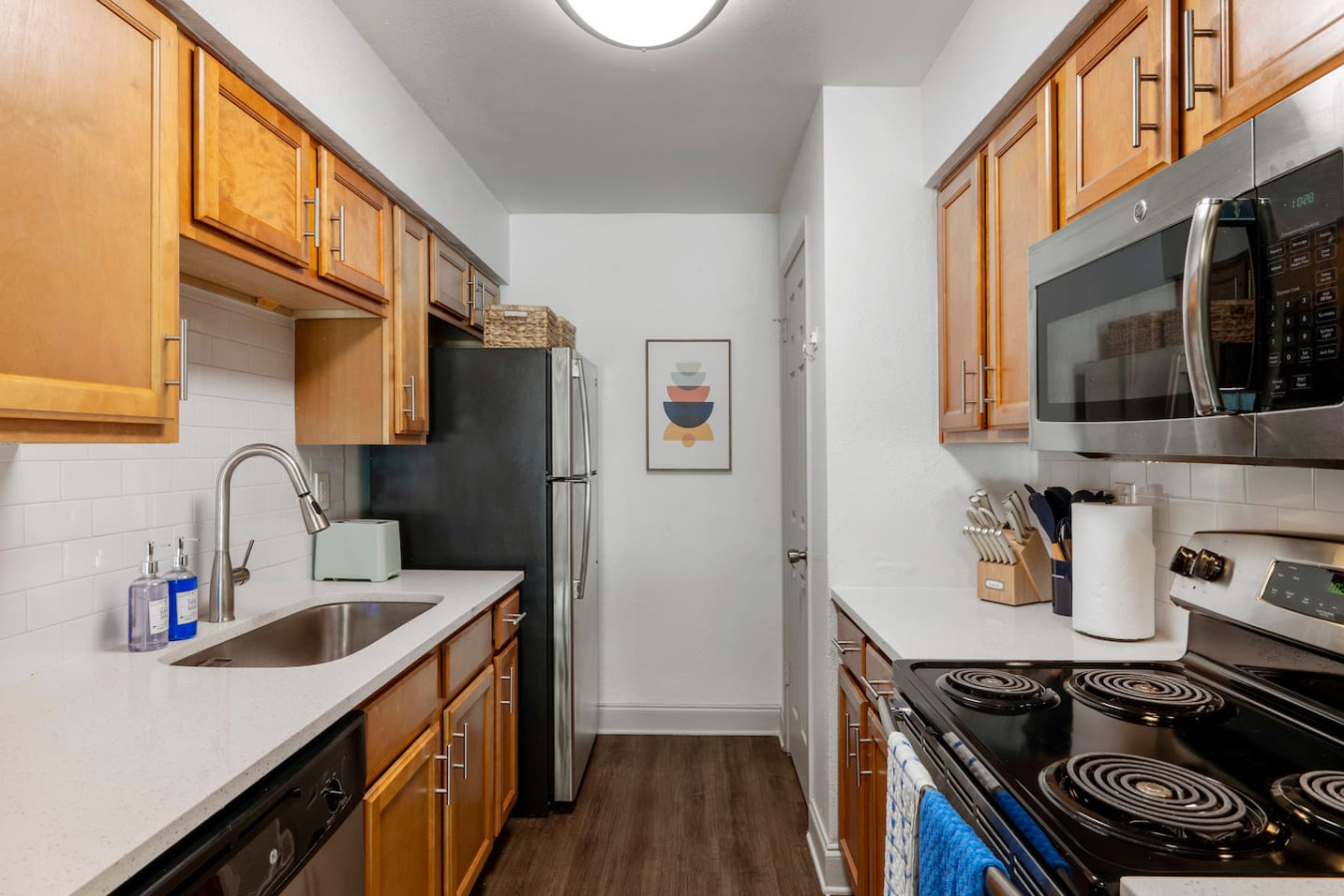 Fully equipped modern kitchen with stainless steel appliances, cookware, and utensils. Prepare meals with ease, brew fresh coffee, or enjoy quick snacks. Bright, functional & perfect for families, long stays, or remote workers seeking home comfort