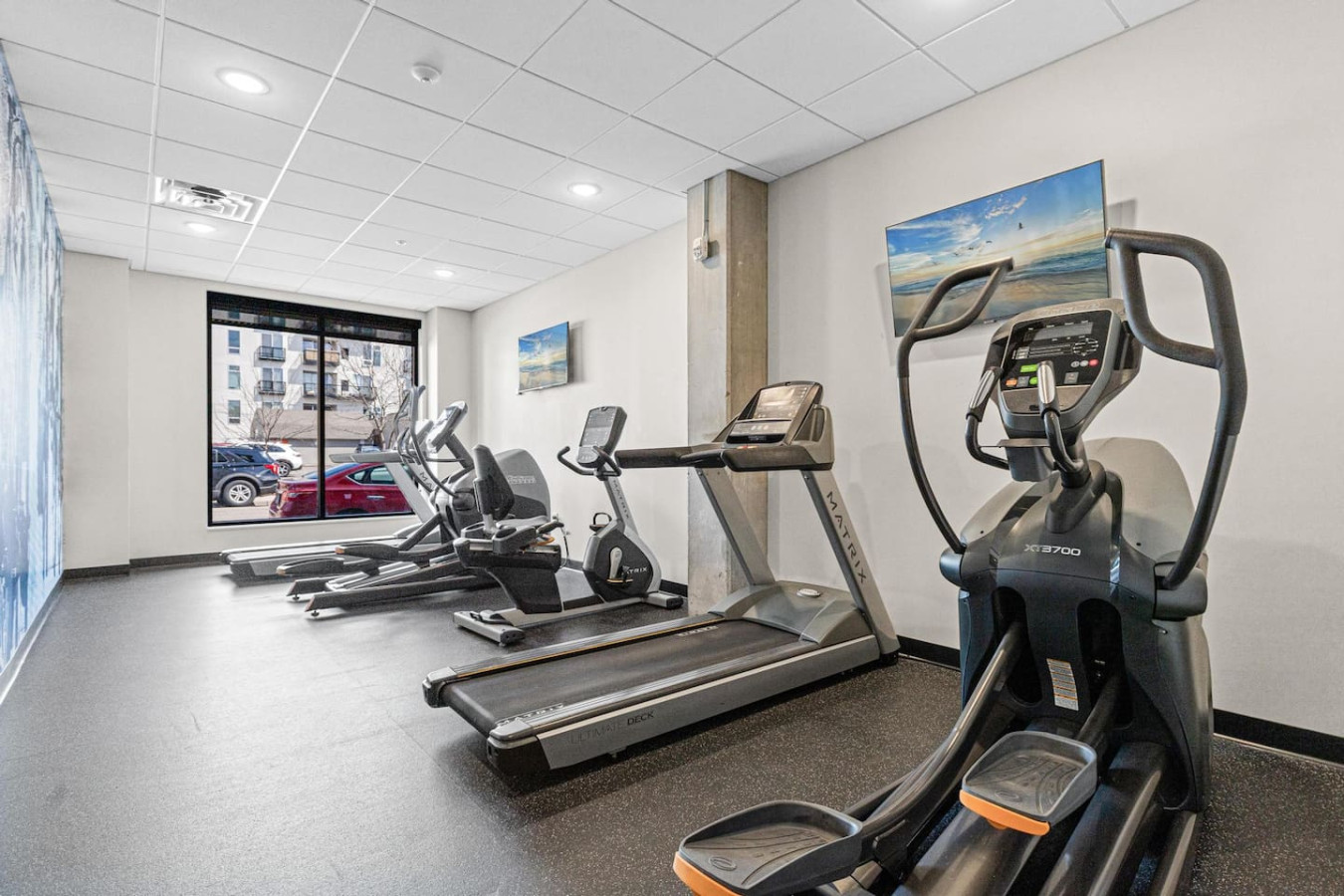 Open floor area with exercise mats, yoga balls, and foam rollers for warm-ups, stretching, or core exercises.