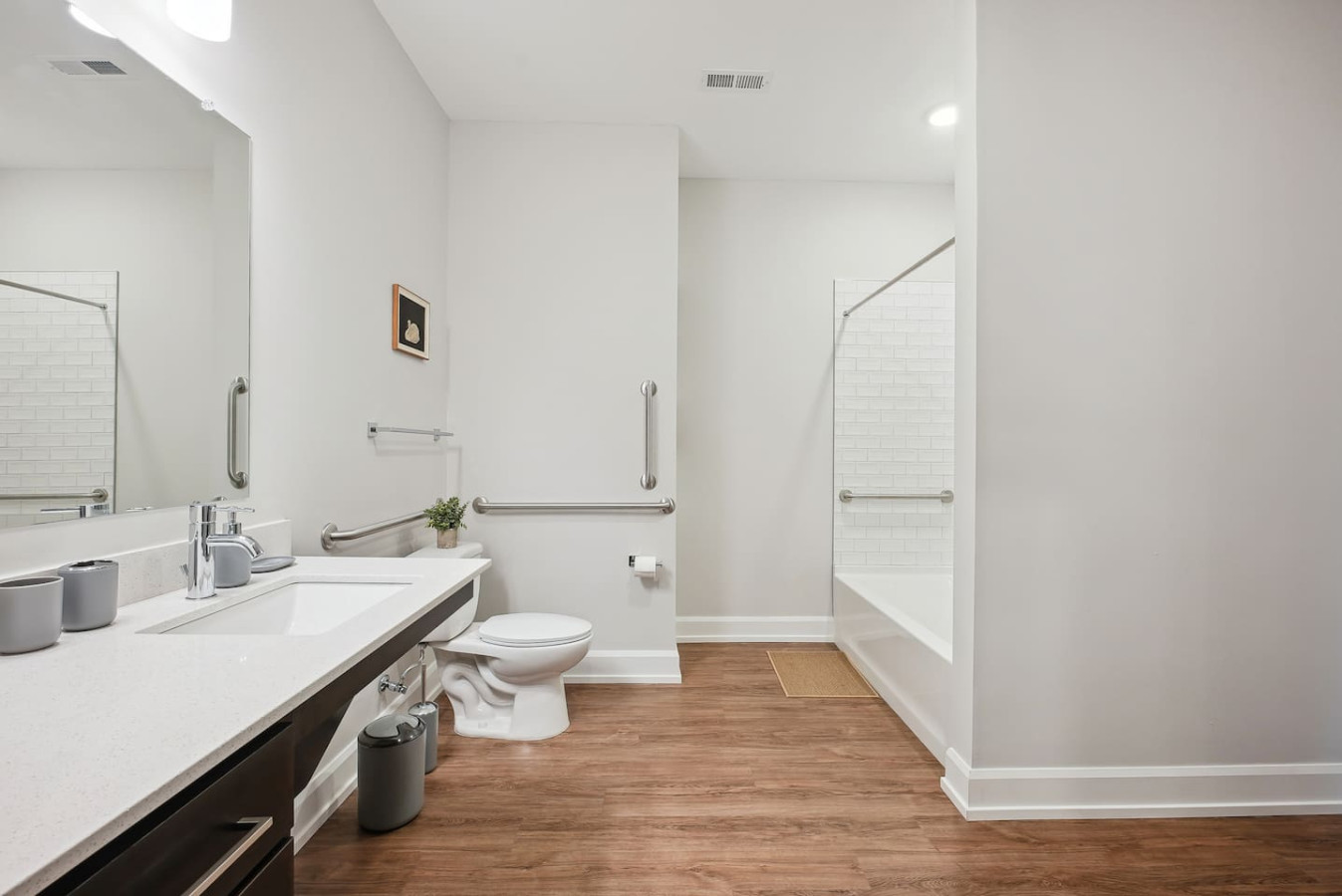 Sleek and clean bathroom vanity with modern fixtures, lush greenery, and premium hand soap. Refresh and unwind in style.