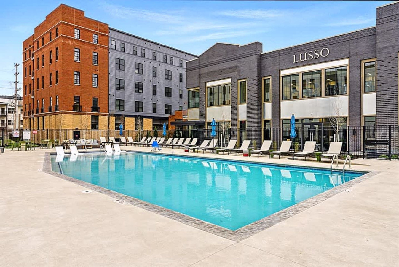 A sparkling resort style pool with ample lounge seating and open deck space. Ideal for sunbathing, swimming, or enjoying peaceful downtime during your stay. The bright atmosphere creates a refreshing place to unwind.