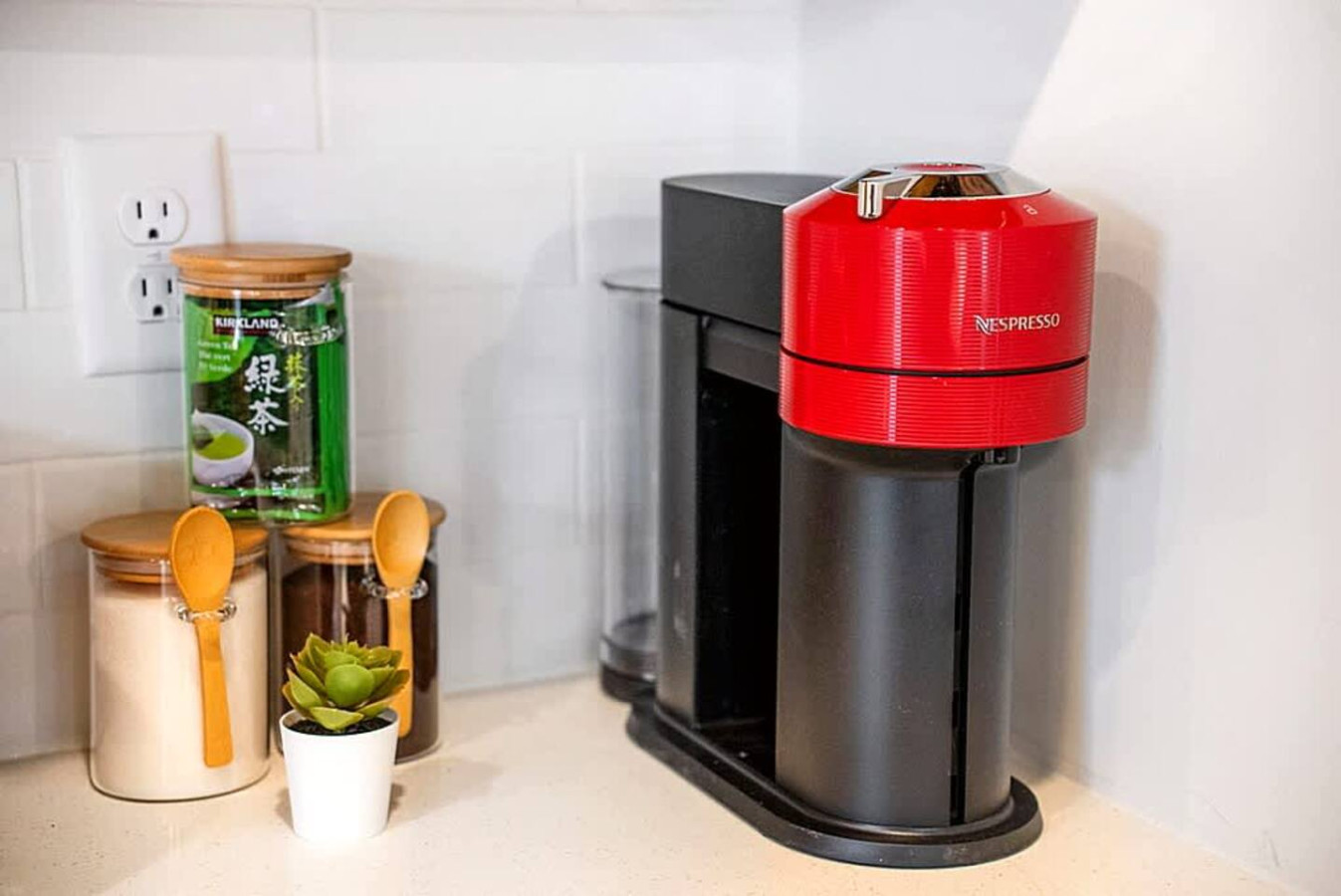 A dedicated coffee station with a modern brewer, utensils, and essentials for easy morning preparation. Guests can start their day with convenience and comfort in this well stocked kitchen area.