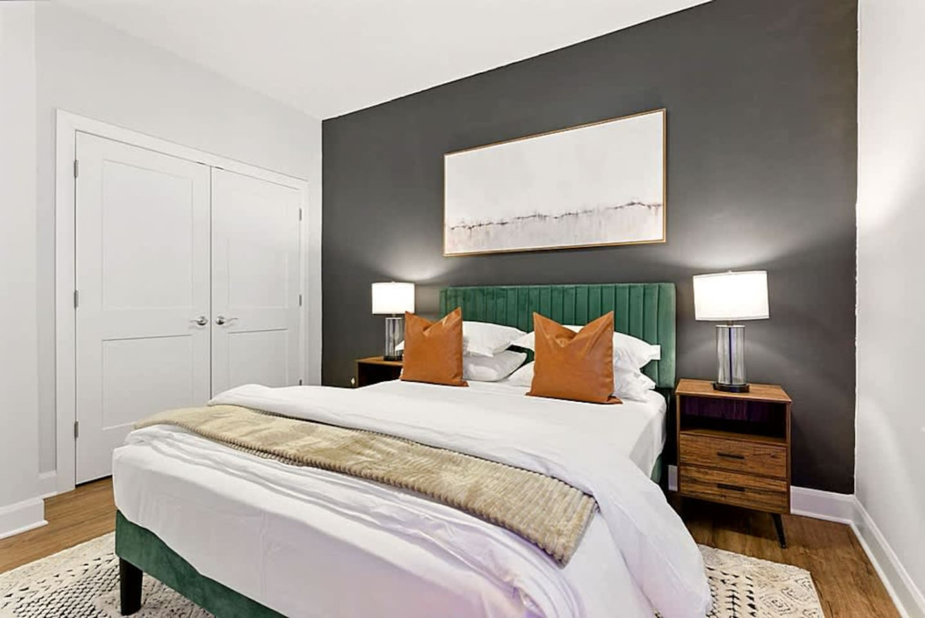 A cozy and inviting bedroom with a comfortable bed, warm lighting, and modern décor. Large windows brighten the space, creating a relaxing environment perfect for restful nights and peaceful mornings during your stay.