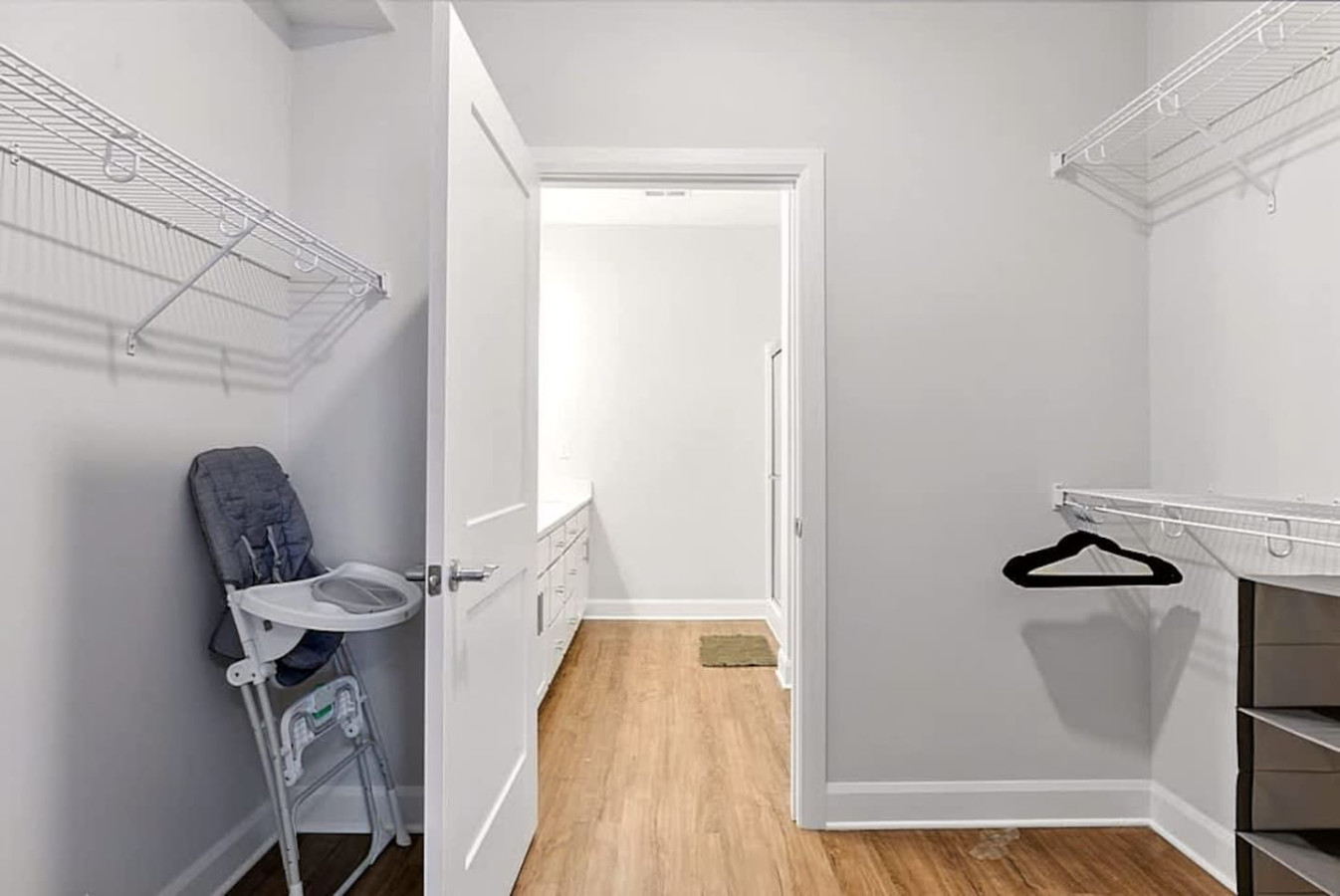 A spacious walk-in closet with shelving, storage, and room for luggage and outfits. Perfect for extended stays, offering plenty of space to unpack and stay organized during your visit.