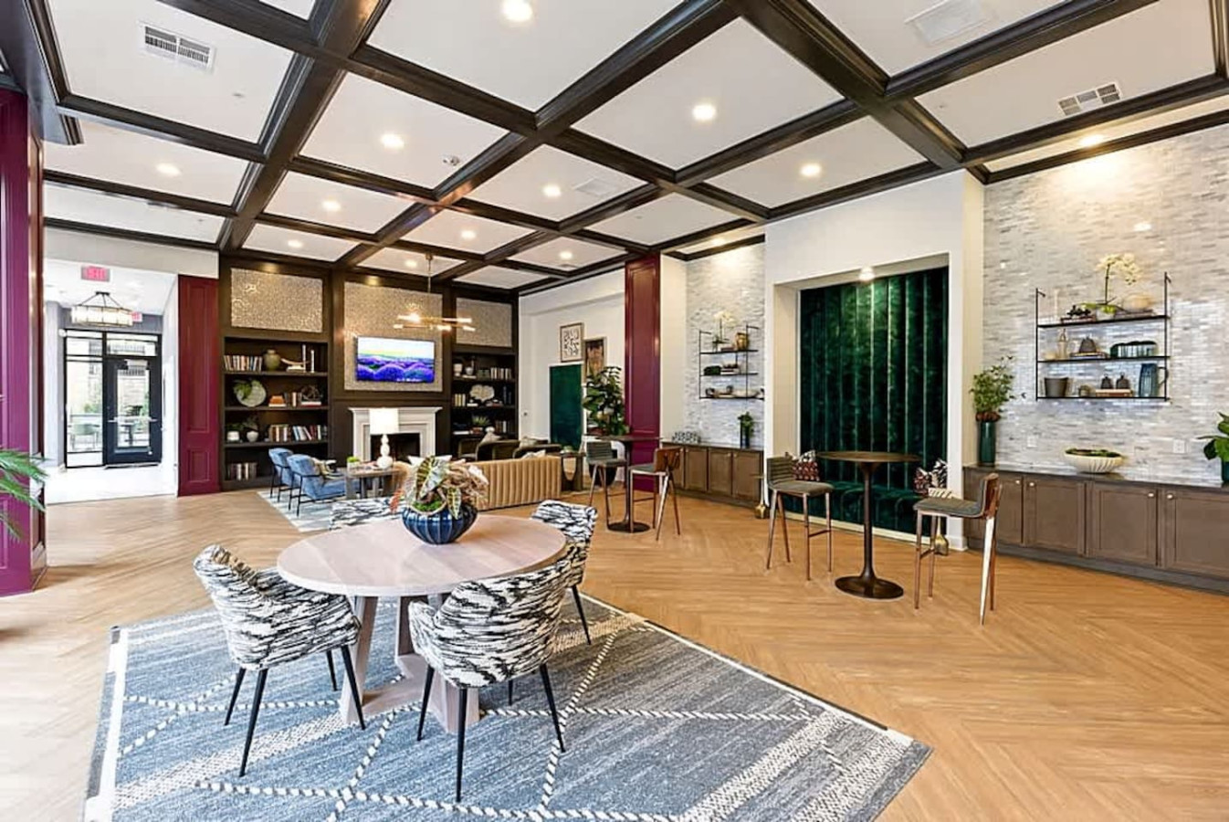 A spacious event room offering multiple seating areas, modern décor, and inviting lighting. Guests can enjoy this versatile space for reading, socializing, working, or simply unwinding in a comfortable community setting.