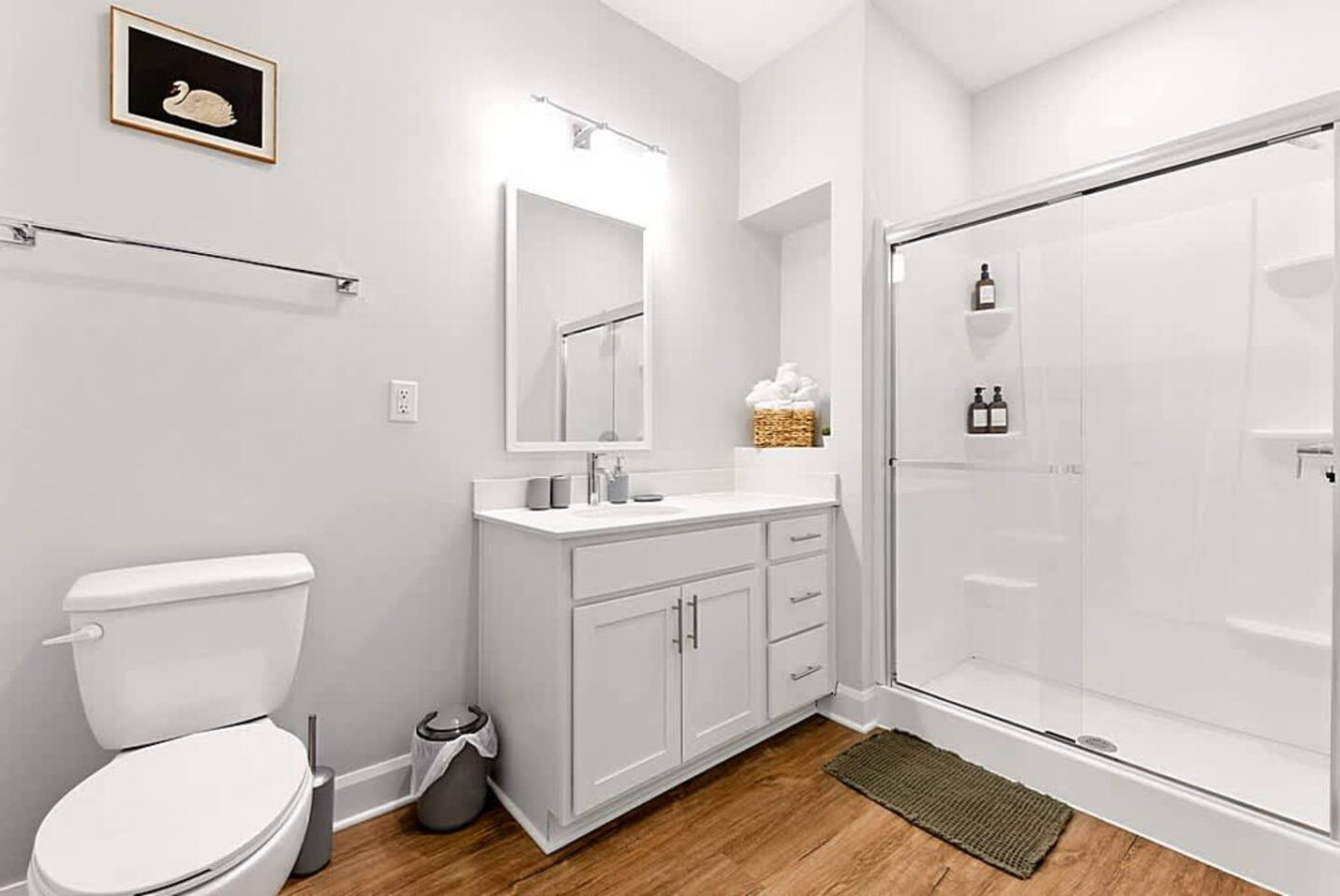 A clean and modern bathroom with bright lighting, a spacious vanity, and a walk-in shower. Thoughtfully designed for comfort and convenience, this space provides a refreshing start to your day throughout your visit.