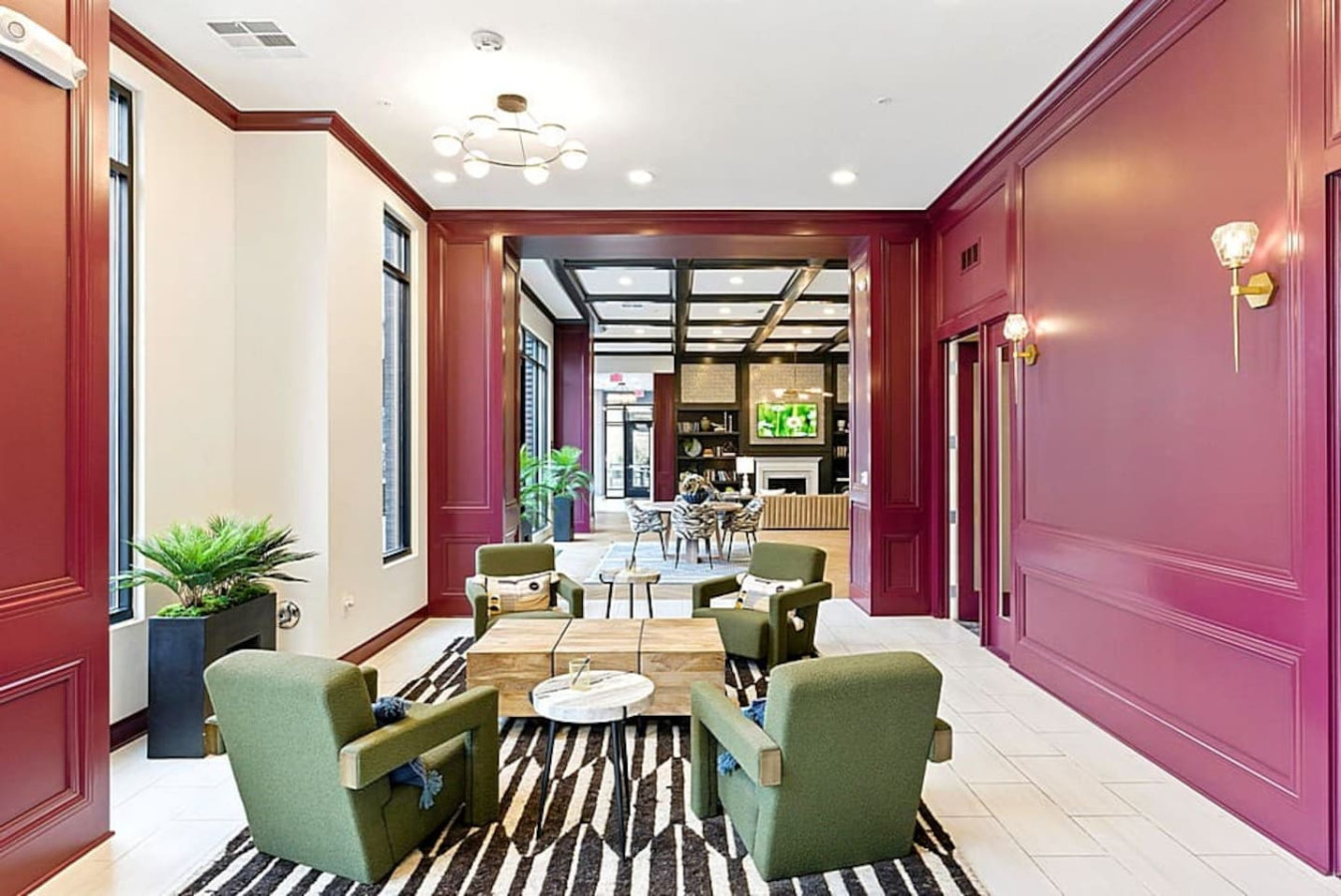 A bright community space featuring floor to ceiling windows, elegant seating, and stylish design elements. Ideal for relaxing, working, or hosting small gatherings in a beautifully maintained environment.