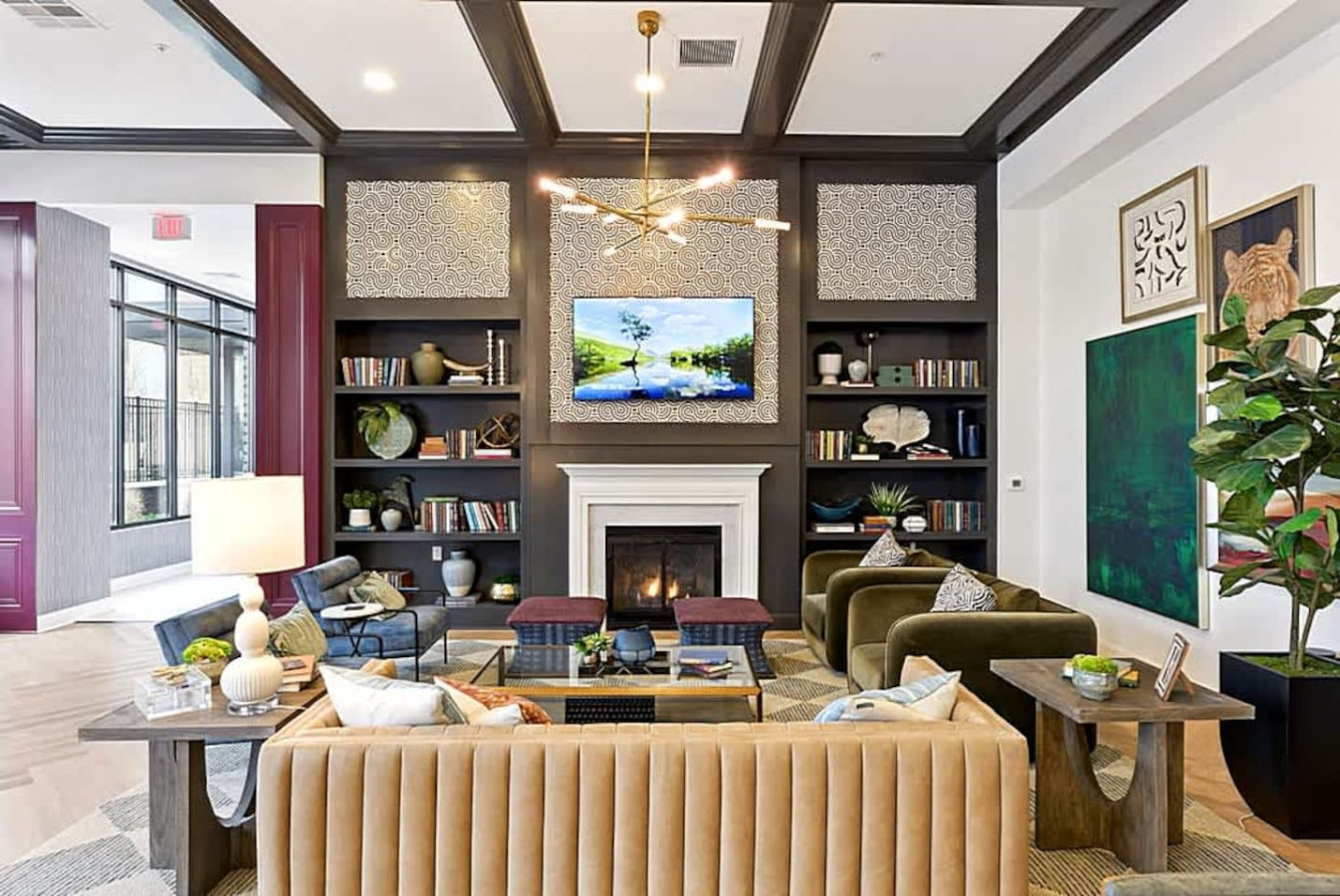 A luxurious community space featuring comfortable seating, a fireplace, and stylish décor. Perfect for relaxing, socializing, or working in a beautifully designed environment that feels both elegant and welcoming.