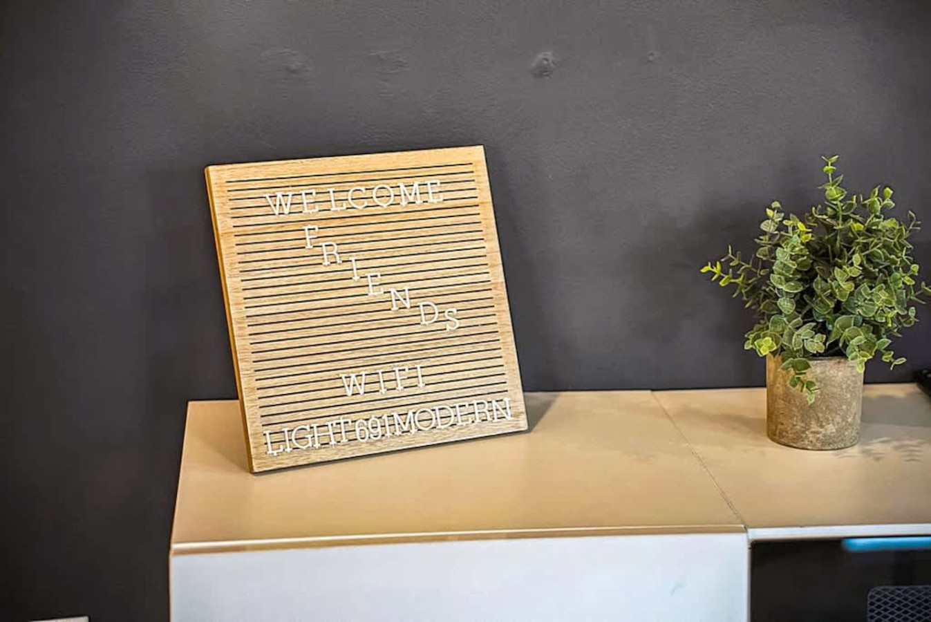 A welcoming decorative corner with a message board and greenery that adds charm and personality to the living space. Thoughtfully styled to create a warm atmosphere for guests to enjoy.