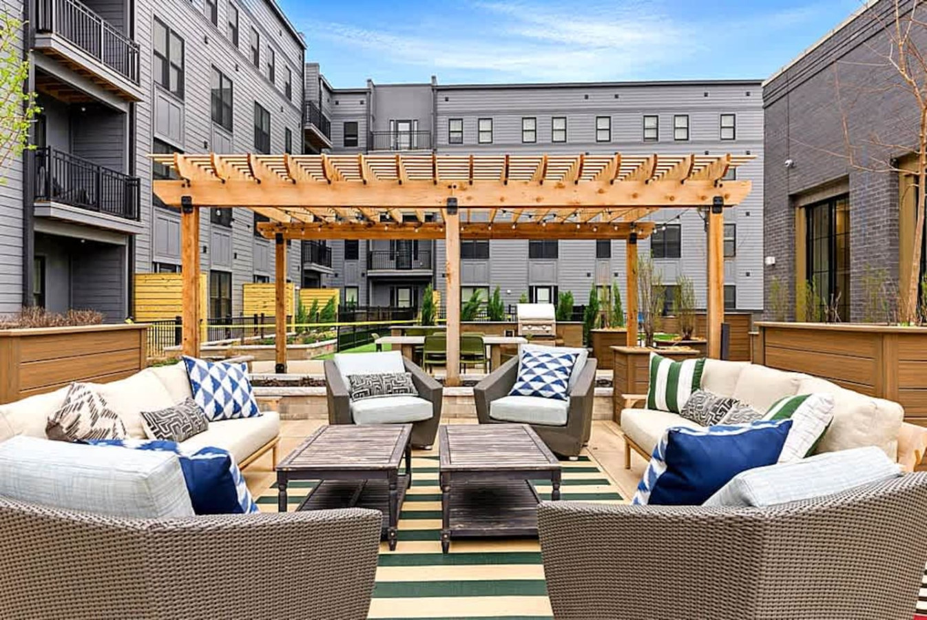 A beautifully designed outdoor lounge with comfortable seating, pergola shade, and stylish decor. This shared space is perfect for relaxing, socializing, or soaking up fresh air in a vibrant community atmosphere.