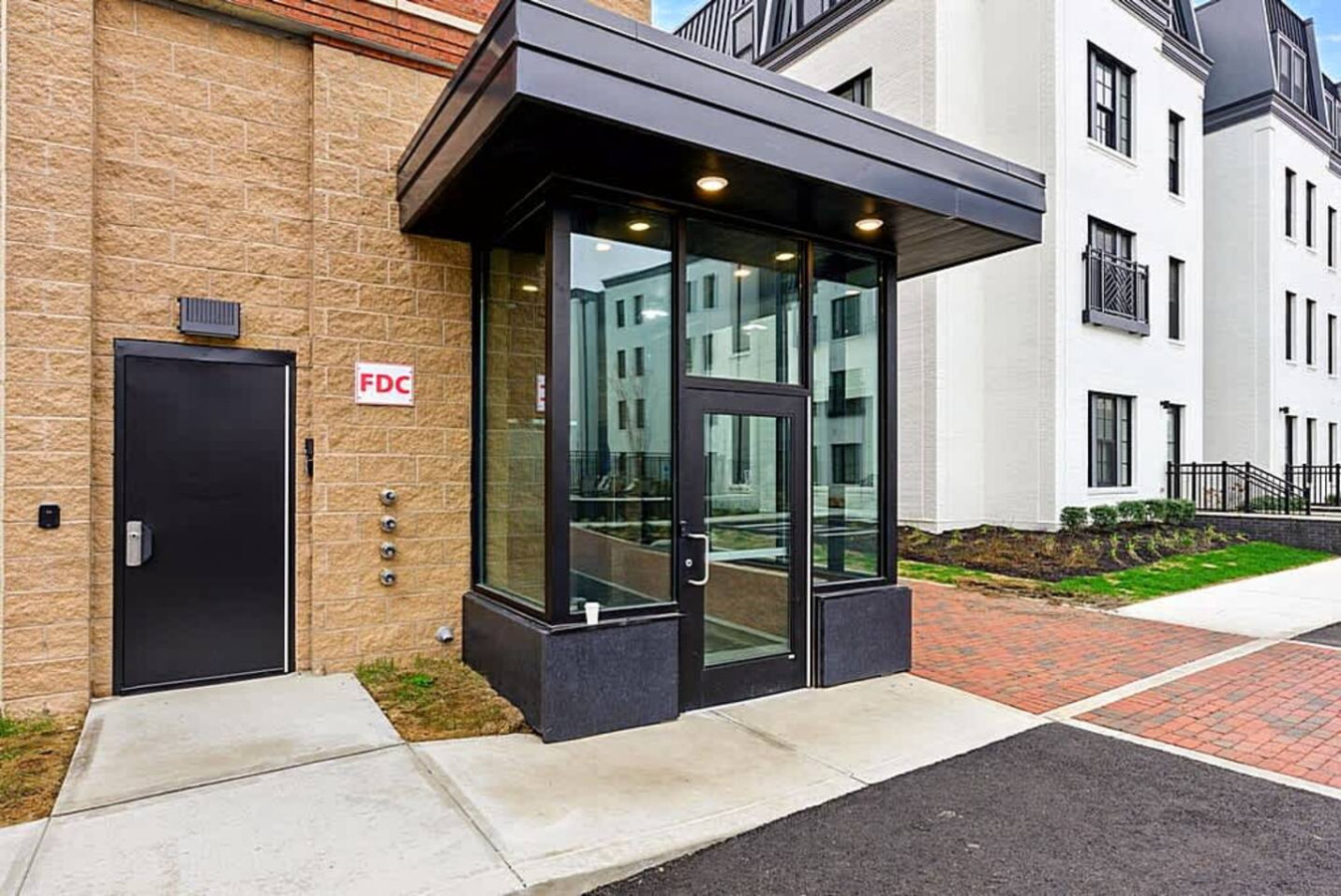 A clean and modern building entrance offering secure access and a welcoming arrival experience. Well maintained landscaping and clear walkways provide a positive first impression for guests during their stay.