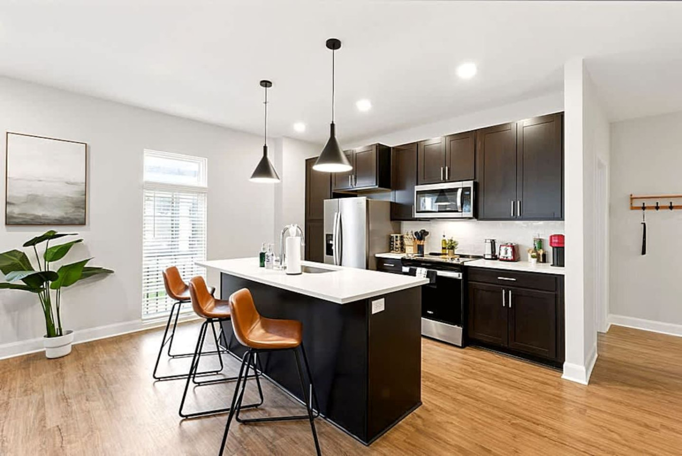 A wide kitchen view showcasing the open layout, large island, and bright lighting. Designed for convenience and social cooking, this space offers everything guests need for easy meals and enjoyable kitchen moments.