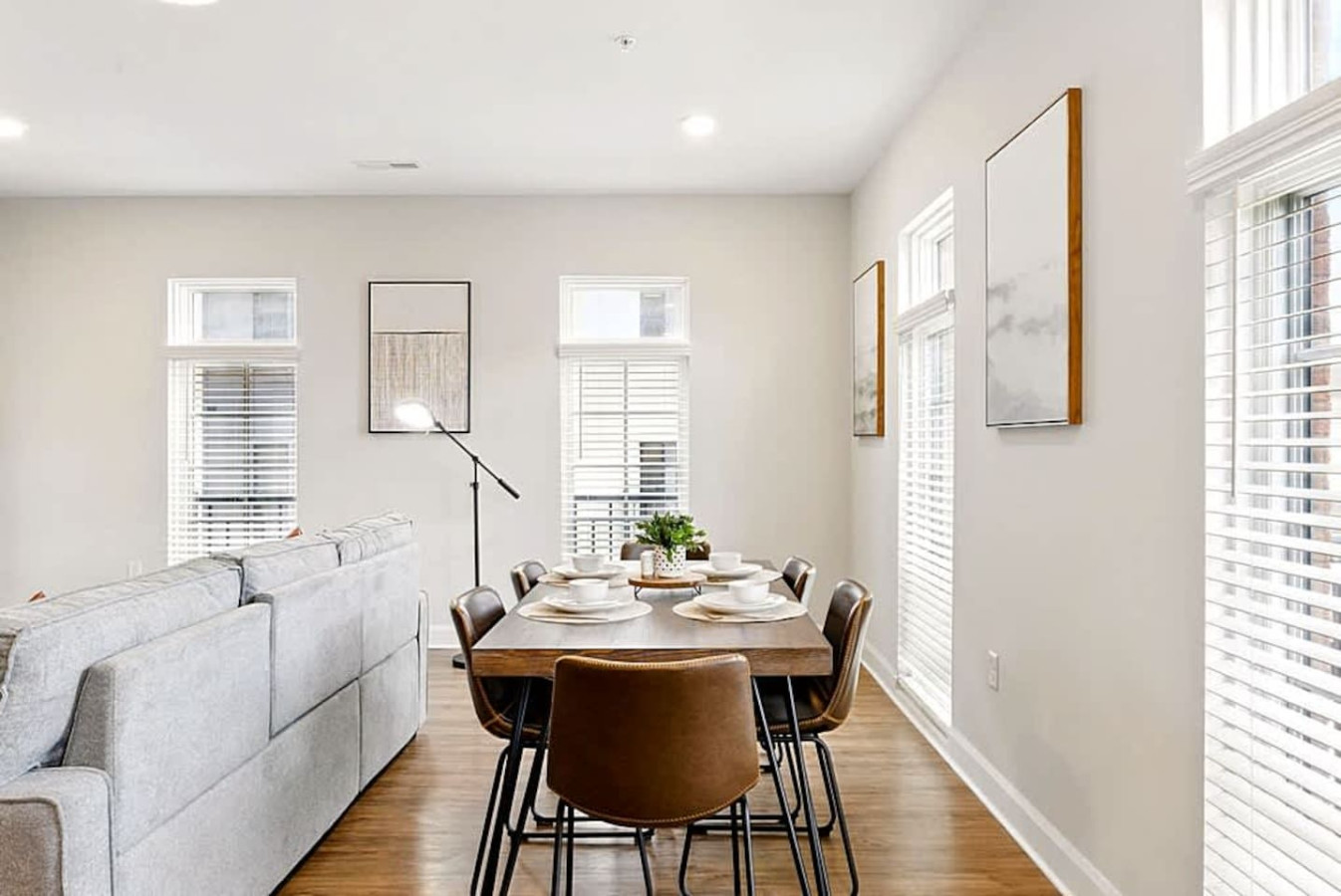 Another airy dining view showcasing large windows, stylish décor, and easy access to the main living spaces. The layout encourages effortless conversation and comfortable dining throughout your stay.