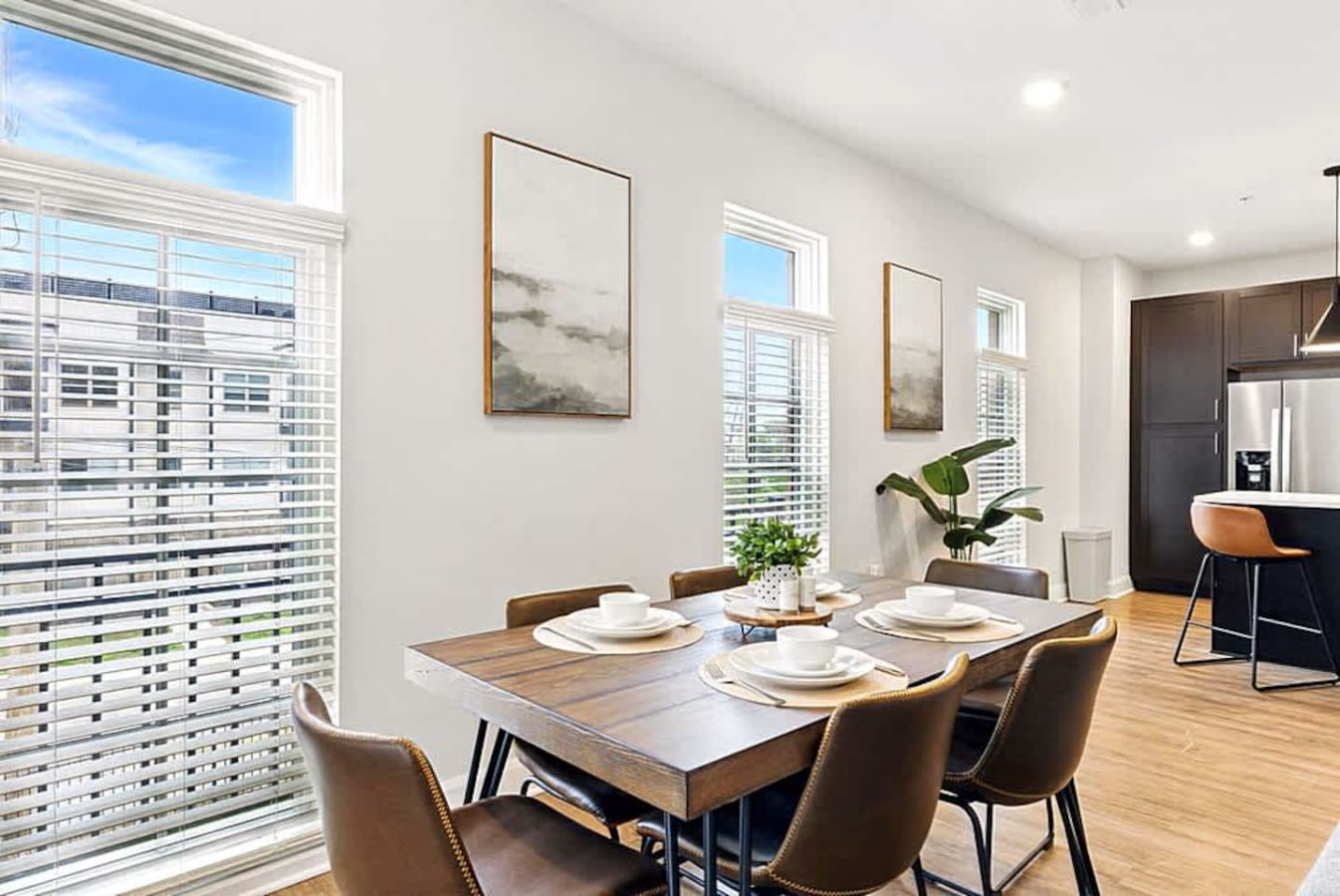 A welcoming dining area featuring a modern table, comfortable seating, and large windows that bring in natural light. This space is perfect for shared meals, remote work, or gathering with loved ones during your stay.