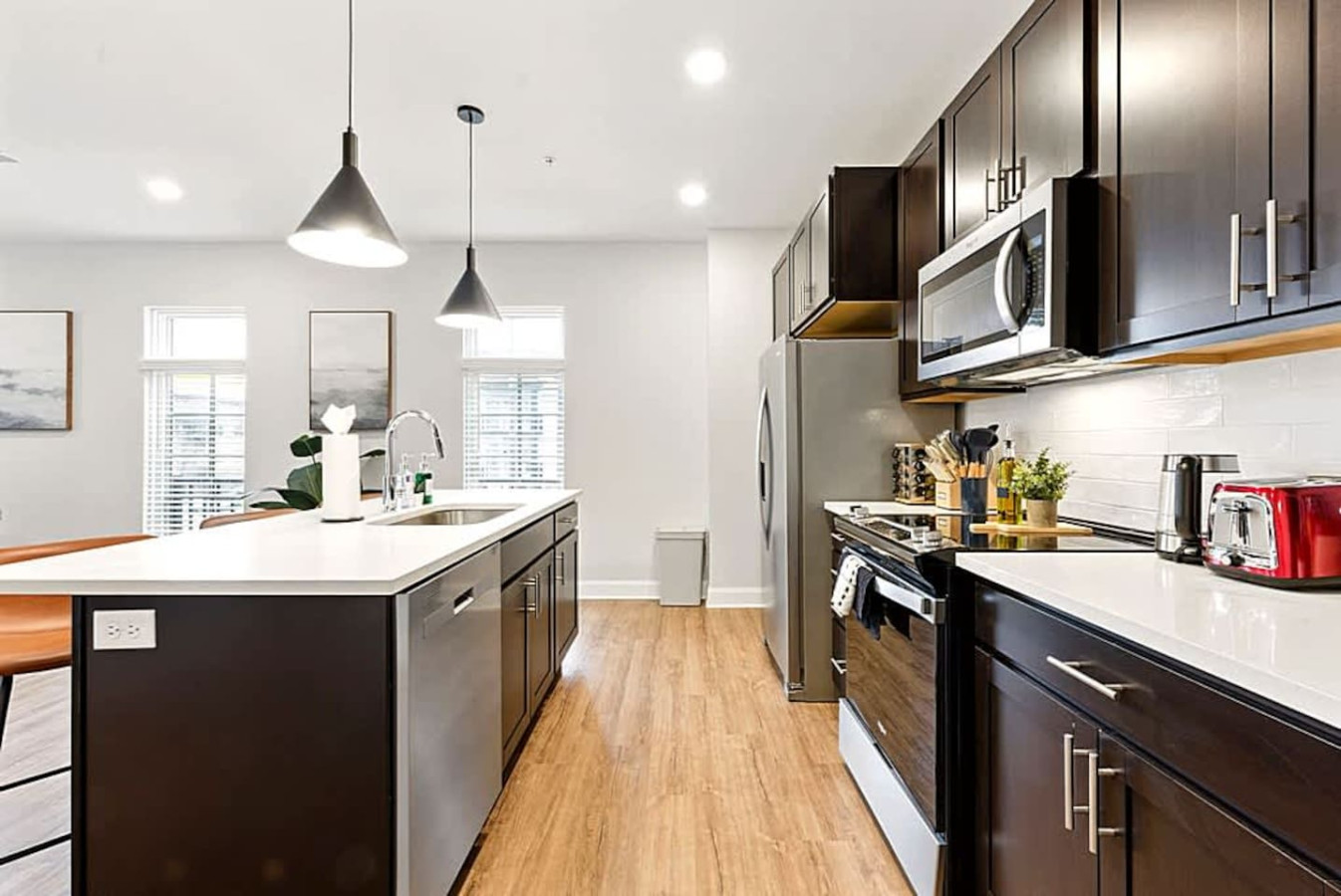 A bright and functional kitchen with roomy counters, full appliances, and an open view into the dining area. Ideal for travelers who prefer home cooked meals or appreciate a spacious and well arranged culinary space.
