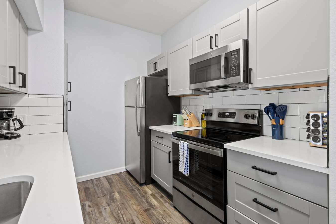 Kitchen has microwave, refrigerator, oven, electric stove, and dishwasher.