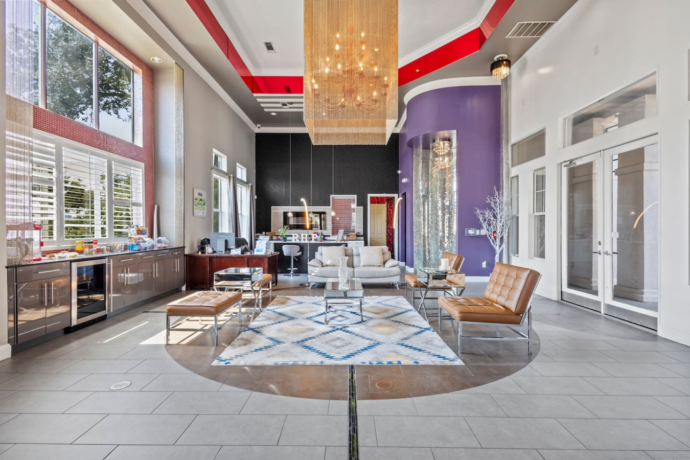 Event room featuring a kitchen, comfortable couch, and TV—perfect for gatherings and entertainment.