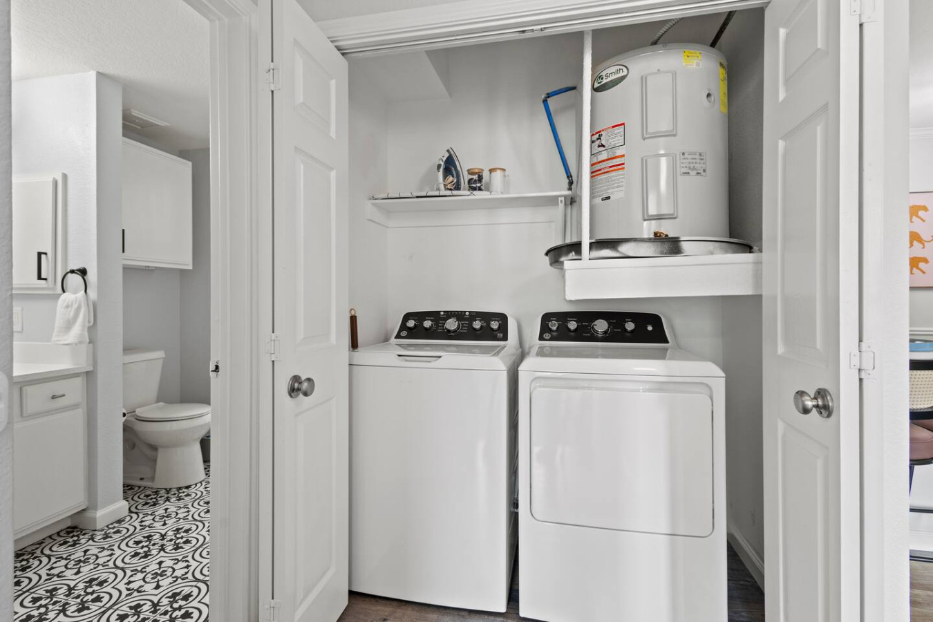 Convenient laundry area with a washer, dryer, and all necessary supplies for your stay in the apartment.
