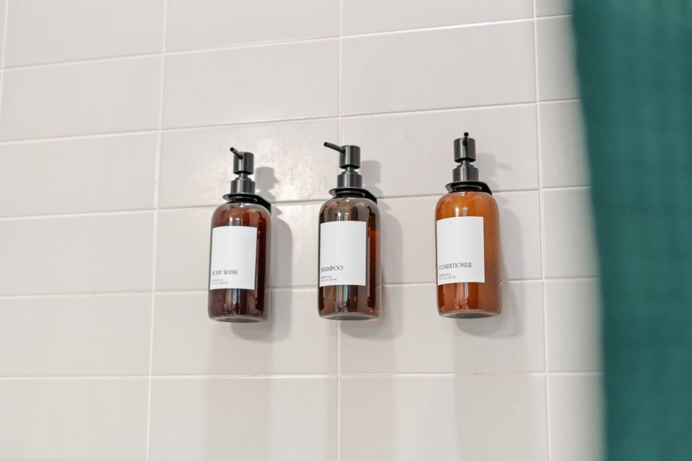 Wall-mounted dispensers with complimentary body wash, shampoo, and conditioner in stylish amber bottles. No need to pack toiletries — we've got you covered for a hassle-free stay.