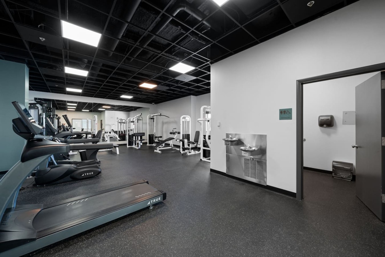 Communal gym has restroom and water fountains.