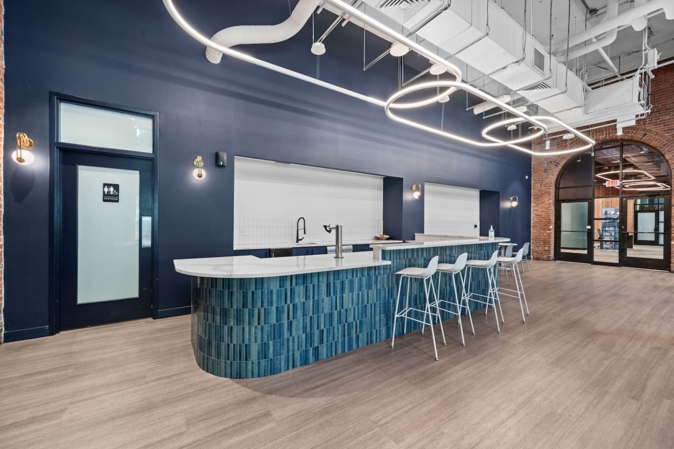 Communal kitchen space with bar and stools