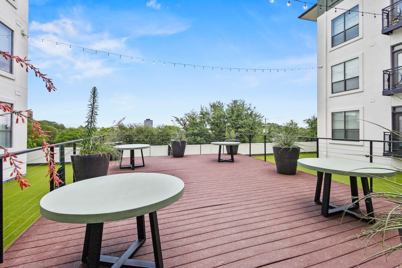 Deck with tables and planters, perfect for relaxing or socializing.