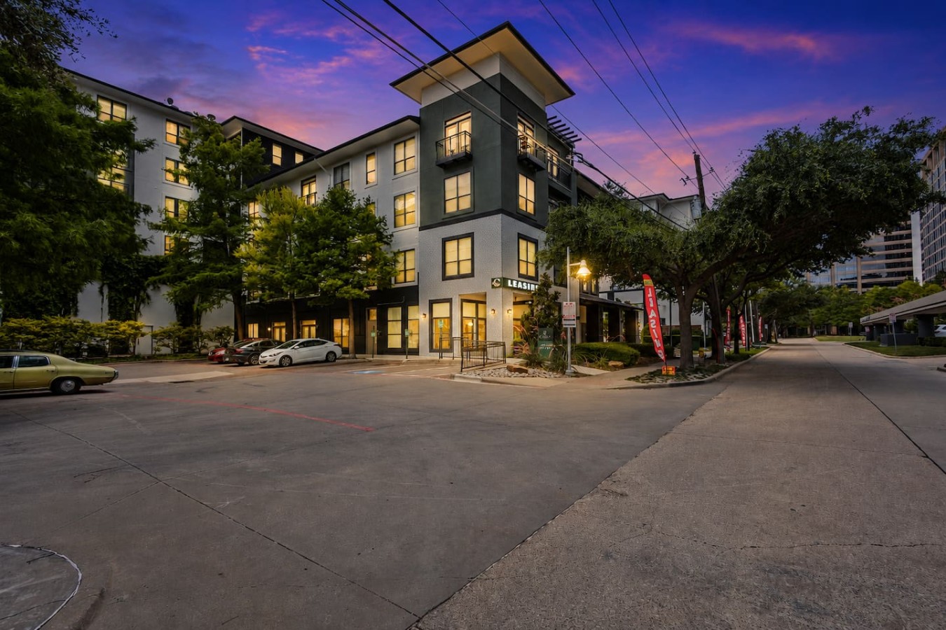 Evening exterior view of the building and entrance area.