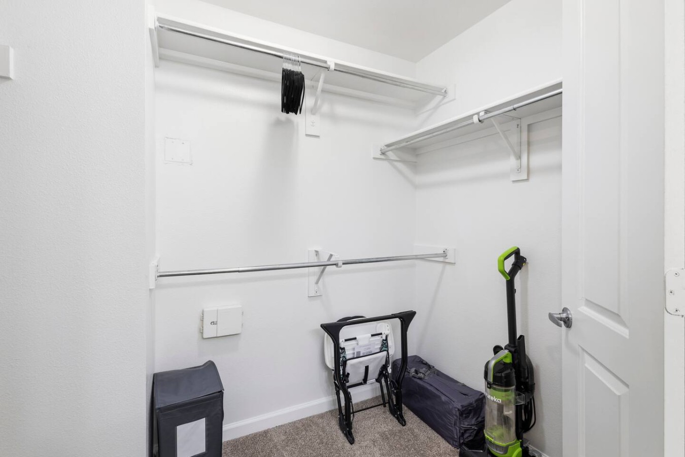 Walk-in closet with shelving and storage space for guests.