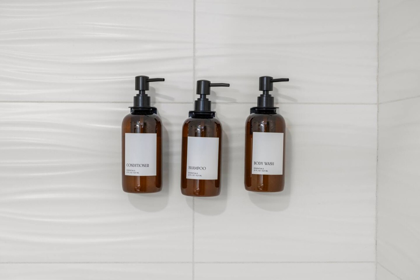 Shower stocked with shampoo, conditioner, and body wash.