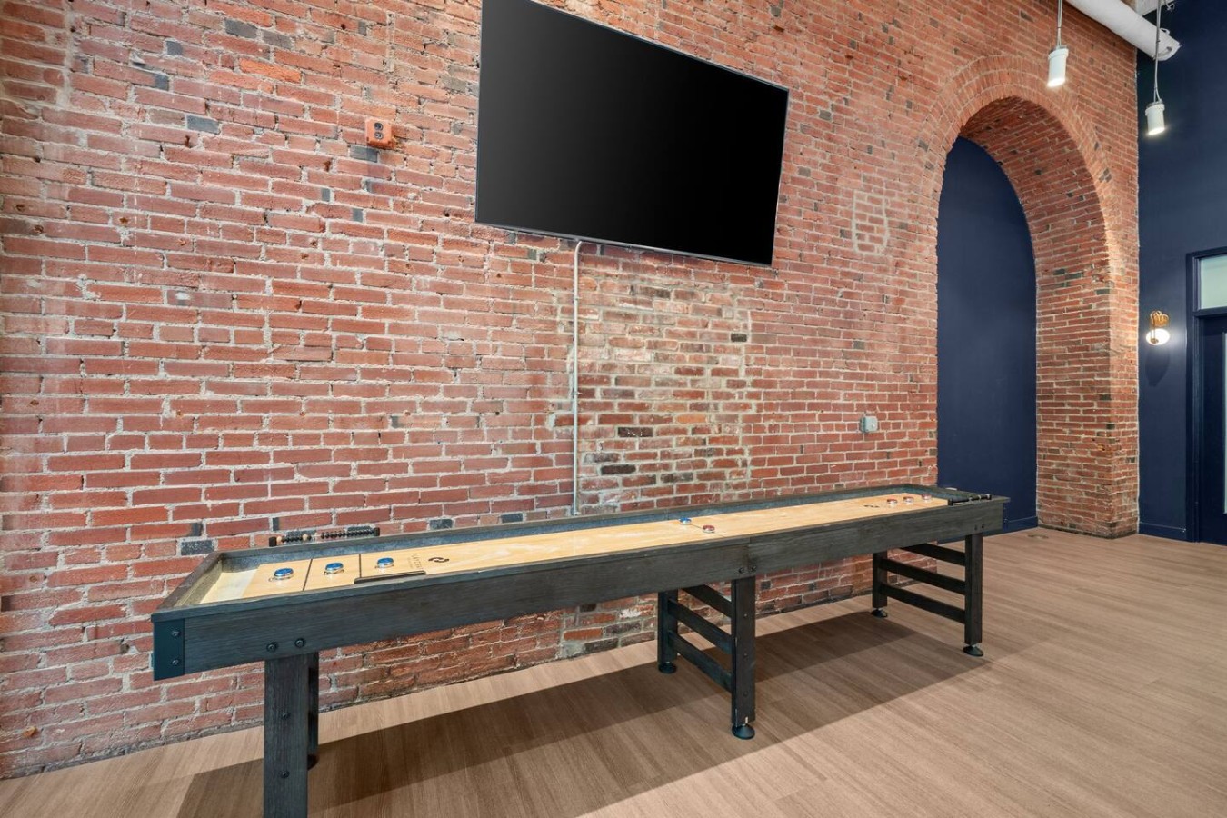 A classic shuffleboard table is one of many amenities to enjoy in our building's array of social spaces