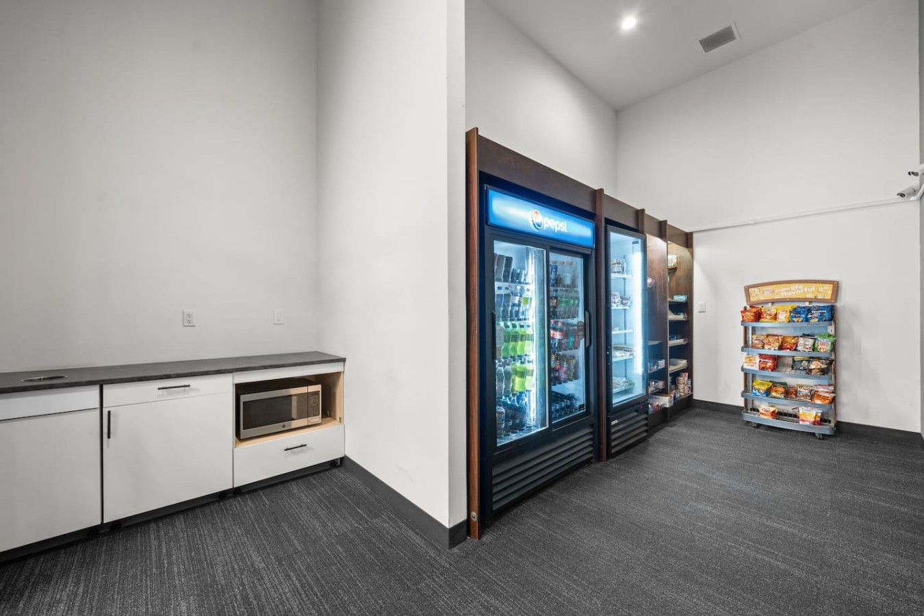 Convenient micro market with self-checkout stocked with food, snacks, drinks, and everyday items