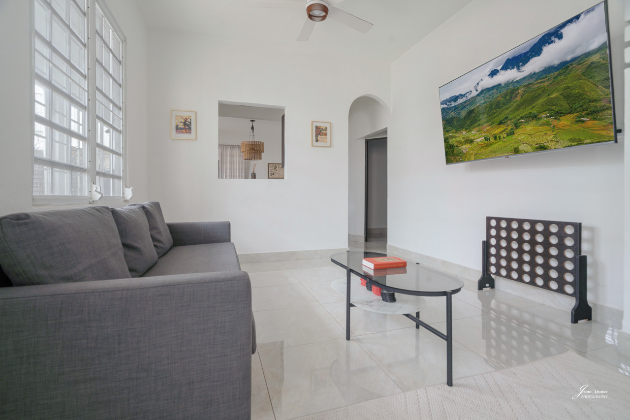Living room with a couch and a flat screen TV — Villa Blanca | San Juan | La Plácita, Miramar