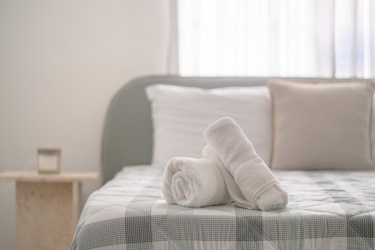 Two white towels folded on a bed — Villa Blanca | San Juan | La Plácita, Miramar