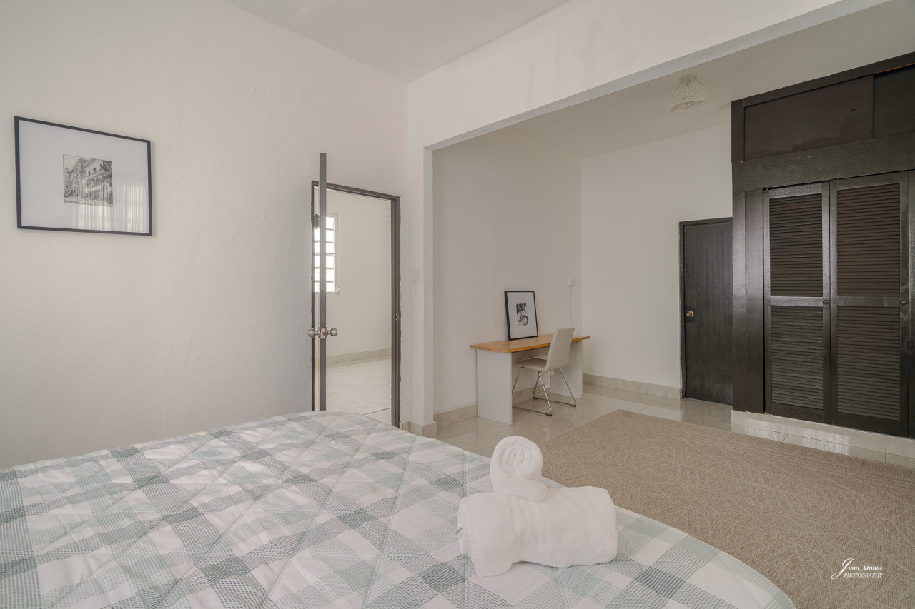 Bedroom with a bed, a chair, and a picture on the wall — Villa Blanca | San Juan | La Plácita, Miramar