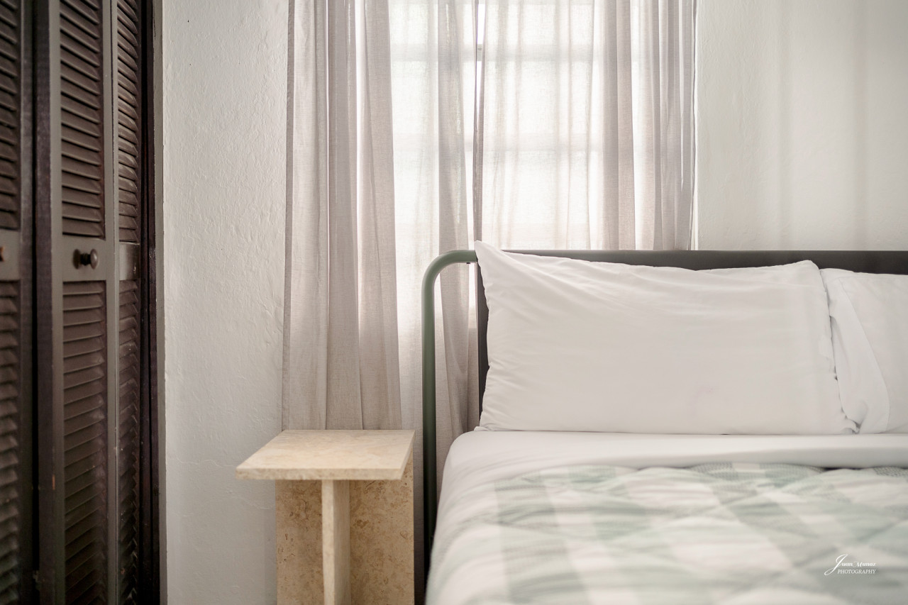 Bedroom with a bed and a window with curtains — Villa Blanca | San Juan | La Plácita, Miramar
